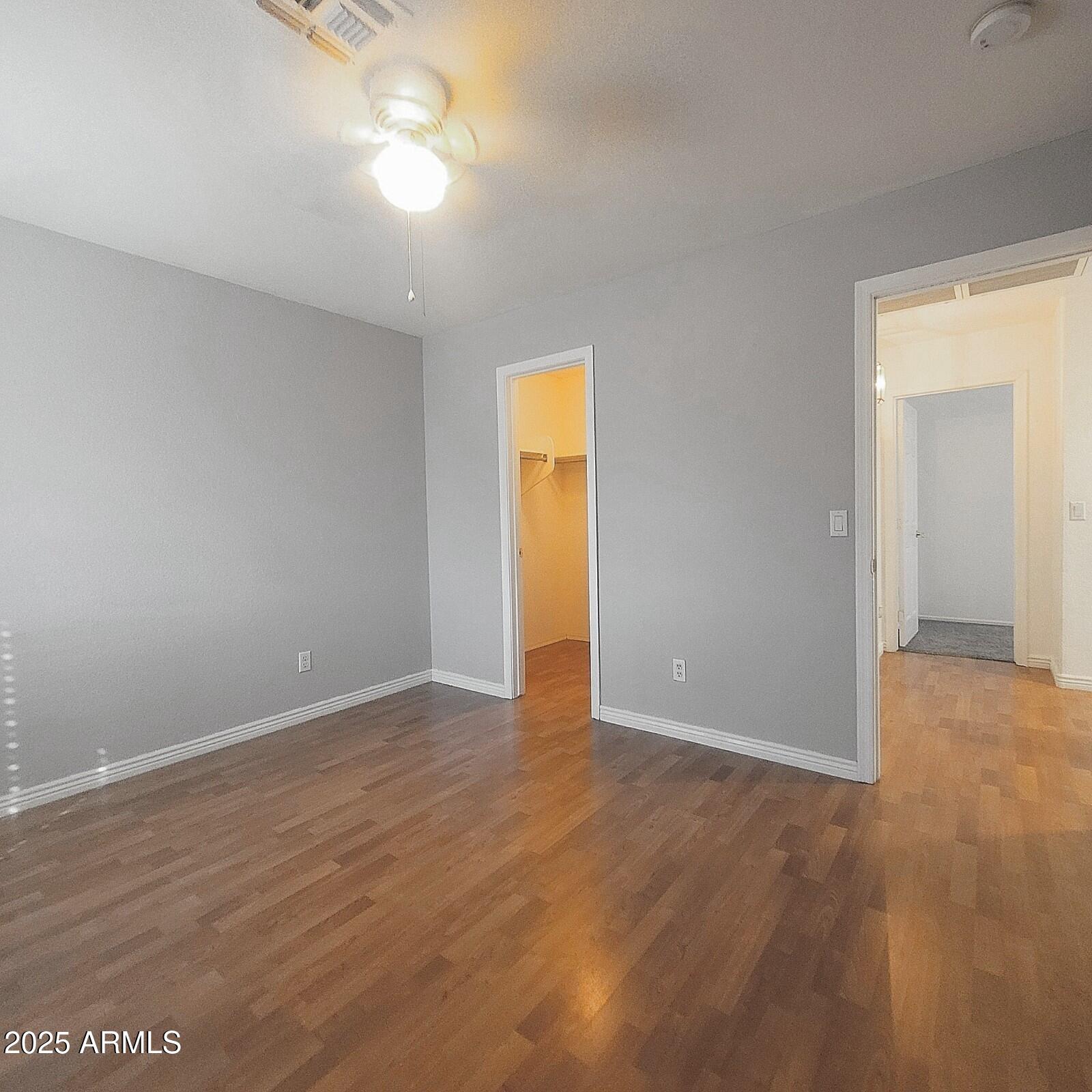 2210 East Paraiso Drive Phoenix, AZ 85024 - Photo 19 of 30 a view of an empty room with wooden floor and a window