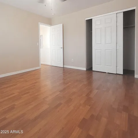 a bathroom with a granite countertop sink a toilet and a mirror
