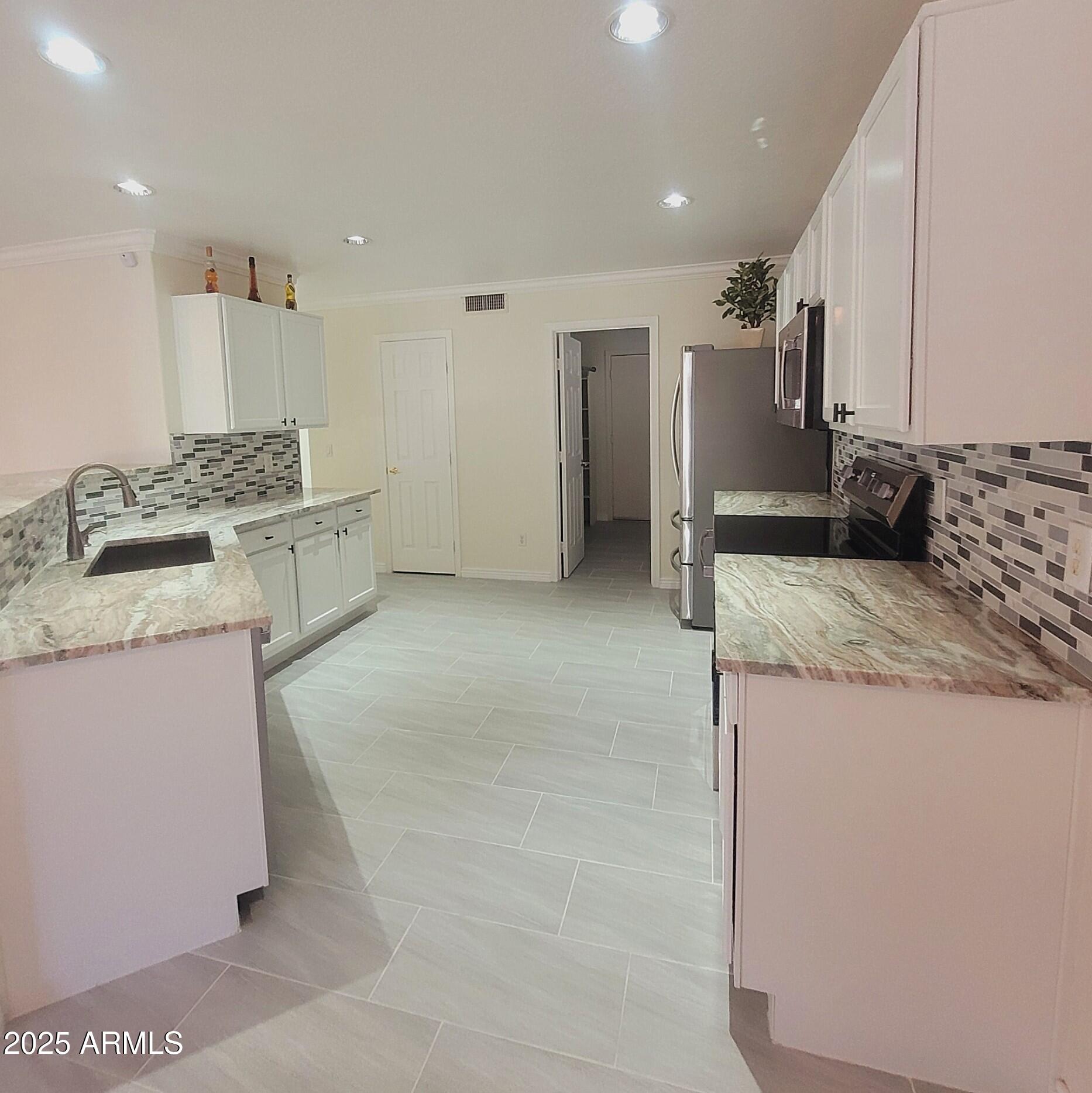 2210 East Paraiso Drive Phoenix, AZ 85024 - Photo 6 of 30 a kitchen with a sink stove and refrigerator