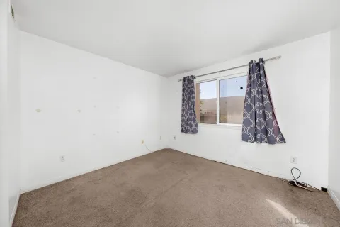 a view of a room with window and a ceiling fan