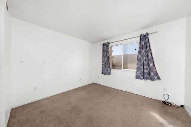 a view of a room with window and a ceiling fan