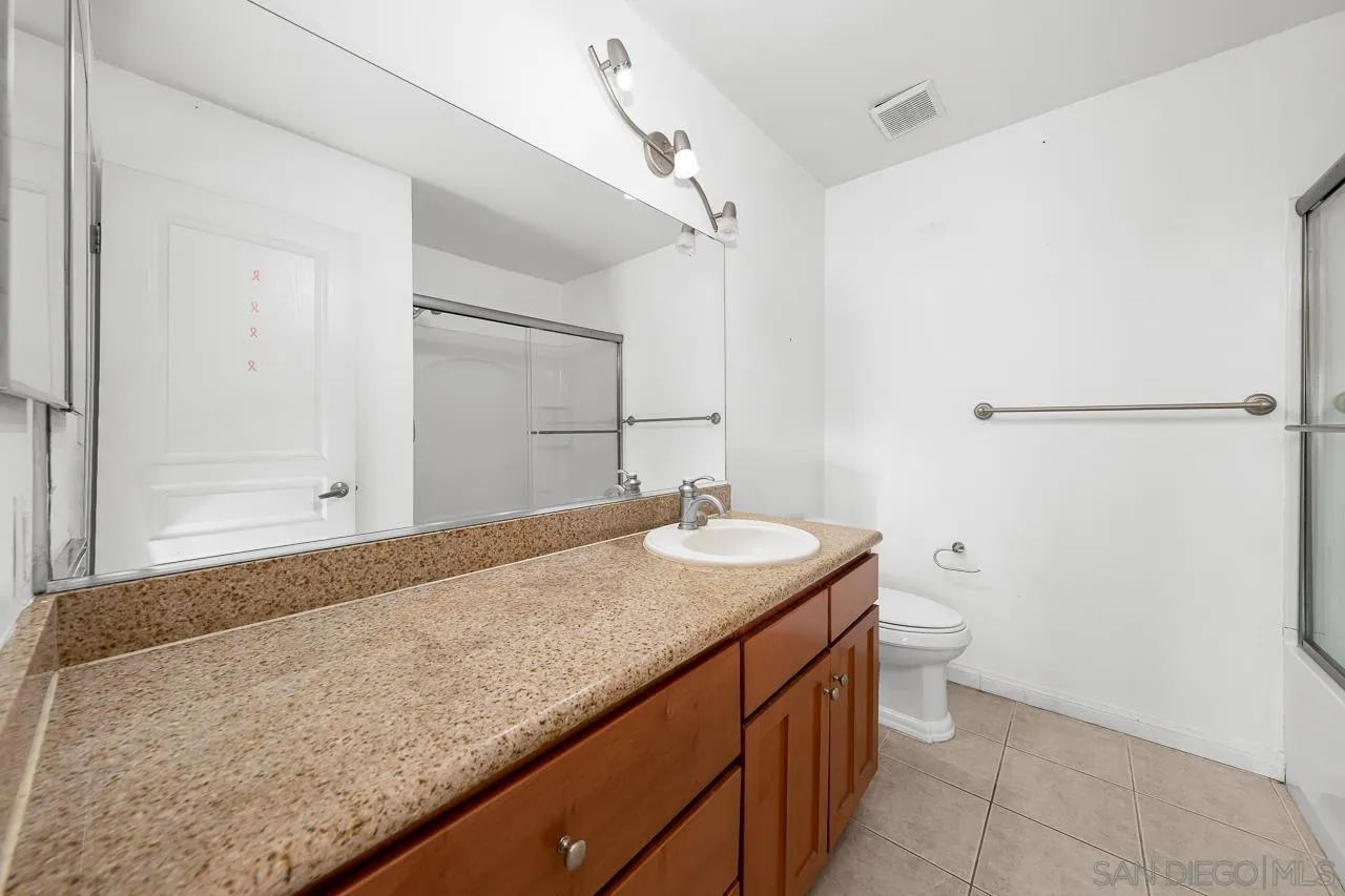 174 Chambers Street, Unit 1 El Cajon, CA 92020 - Photo 17 of 37 a bathroom with a granite countertop sink and toilet