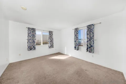 an empty room with wall painting and a window