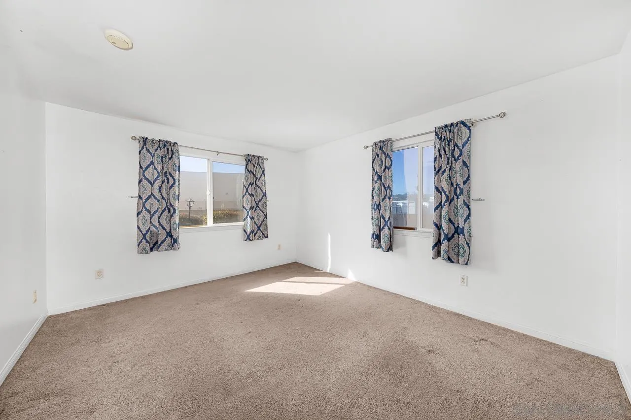 174 Chambers Street, Unit 1 El Cajon, CA 92020 - Photo 18 of 37 an empty room with wall painting and a window