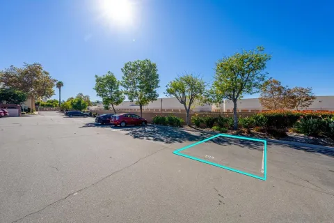 a view of a street with a car parked on the road