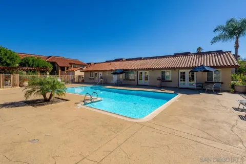 a view of a house with swimming pool and porch