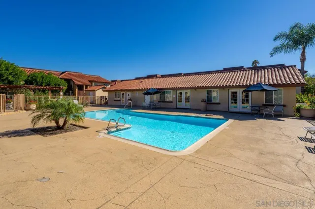 a view of a house with swimming pool and porch