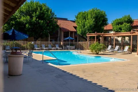a view of a house with swimming pool and sitting area