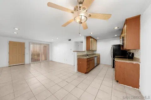 a kitchen with stainless steel appliances a refrigerator sink and microwave