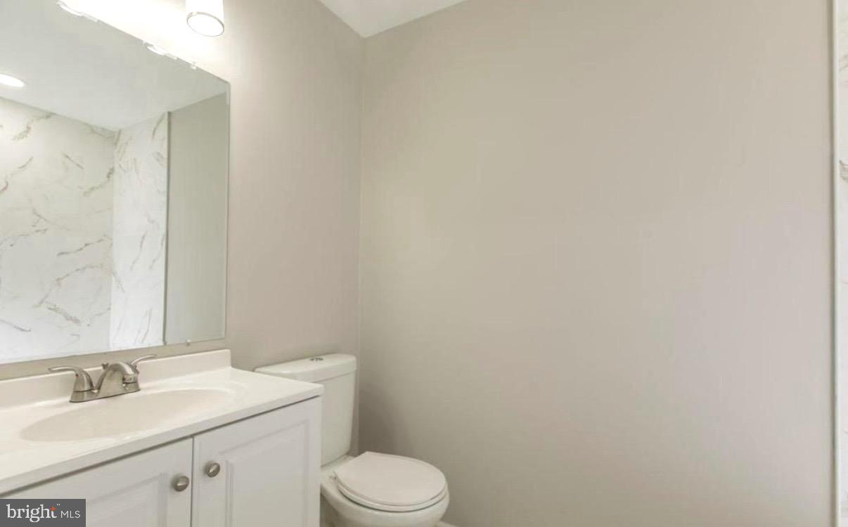 405 Quail Road Marlton, NJ 08053 - Photo 7 of 20 a bathroom with a granite countertop toilet and sink