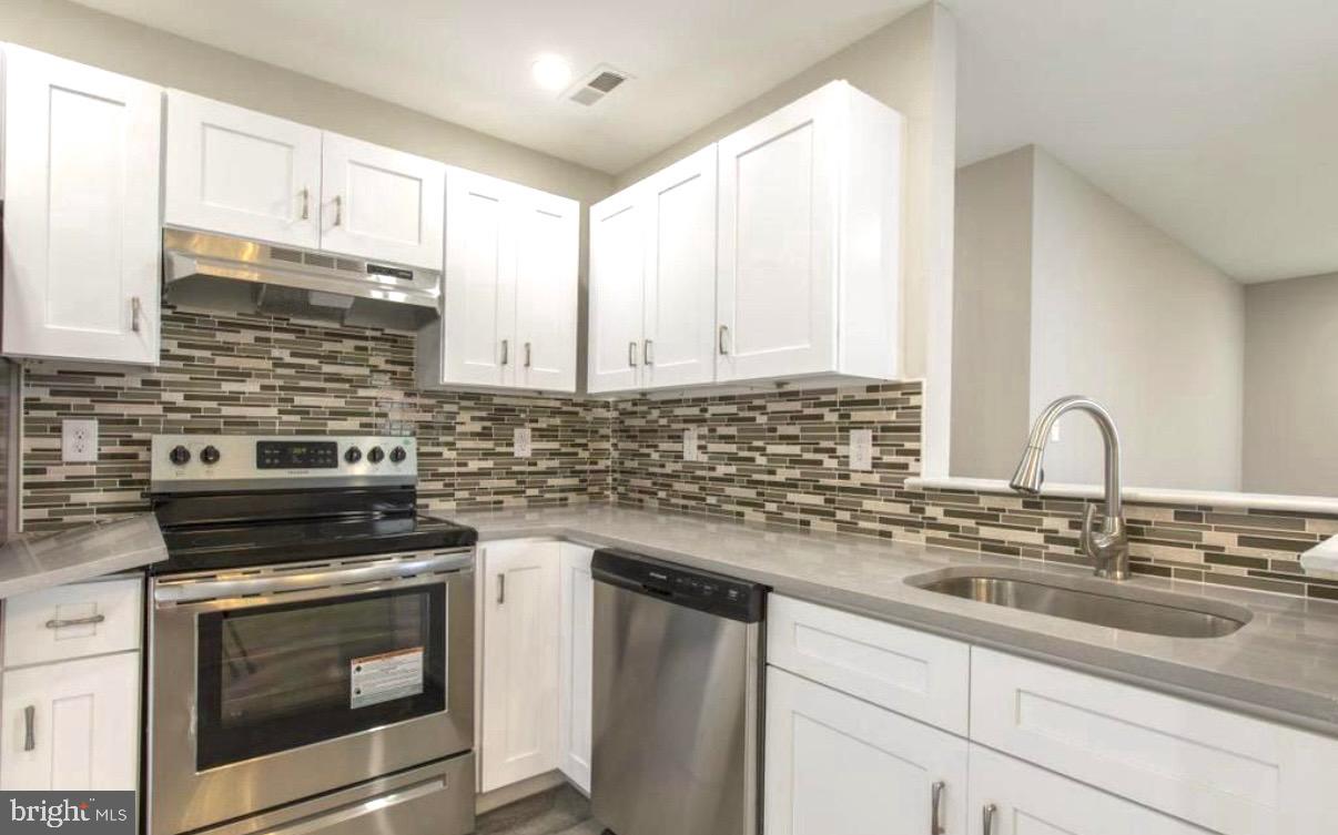 405 Quail Road Marlton, NJ 08053 - Photo 8 of 20 a kitchen with granite countertop a sink stainless steel appliances and cabinets