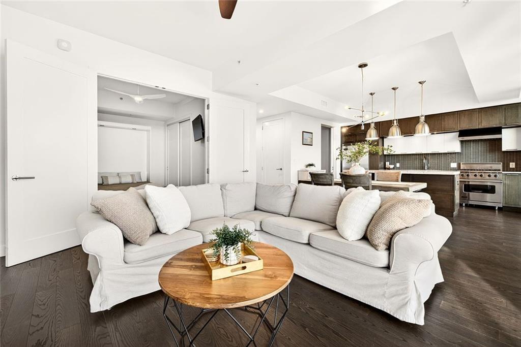 1820 Peachtree Road Northwest, Unit 905 Atlanta, GA 30309 - Photo 11 of 41 a living room with furniture kitchen view and a wooden floor