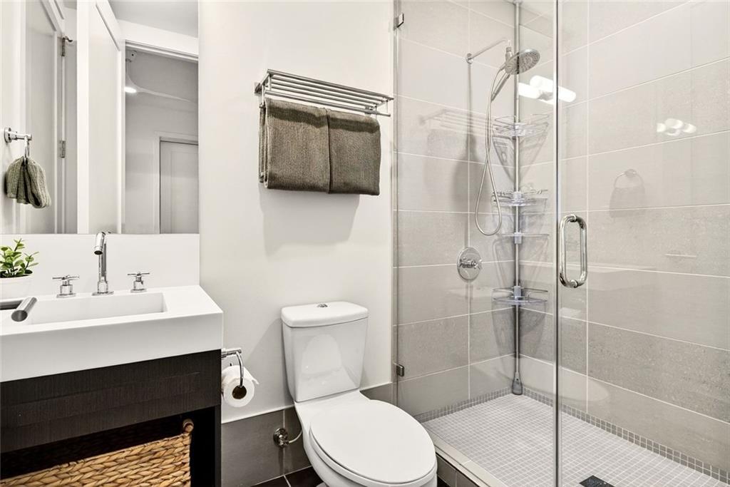 1820 Peachtree Road Northwest, Unit 905 Atlanta, GA 30309 - Photo 13 of 41 a bathroom with a sink toilet and shower