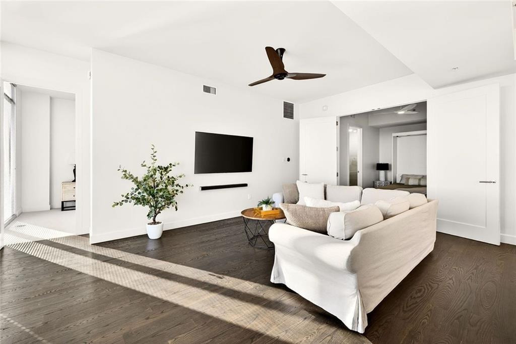 1820 Peachtree Road Northwest, Unit 905 Atlanta, GA 30309 - Photo 14 of 41 a living room with furniture and a flat screen tv