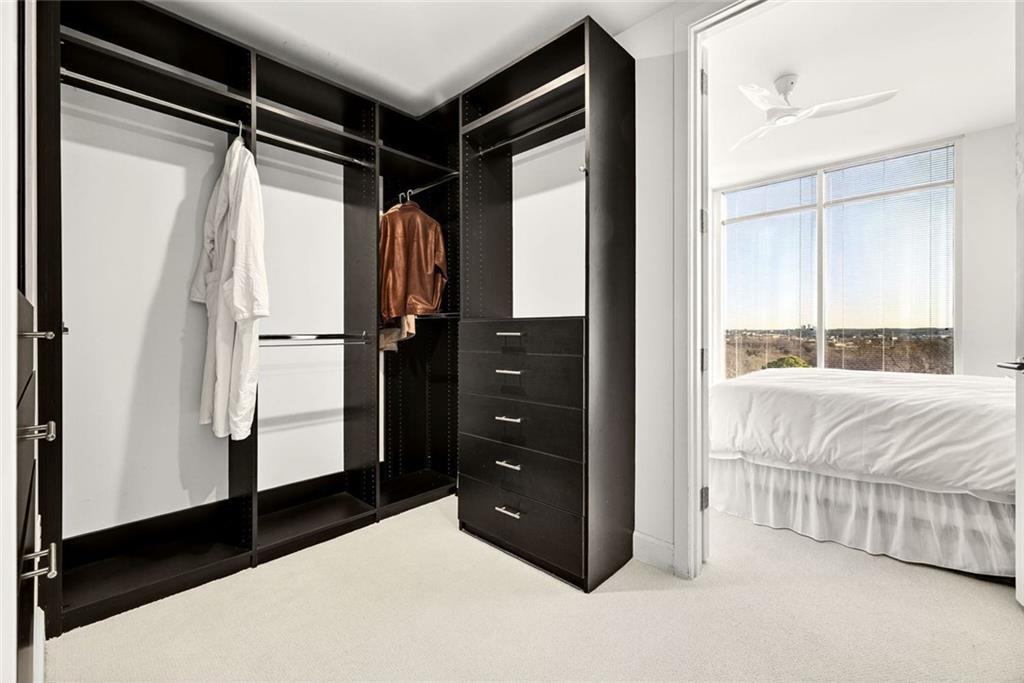 1820 Peachtree Road Northwest, Unit 905 Atlanta, GA 30309 - Photo 17 of 41 a bedroom with a bed and a dresser