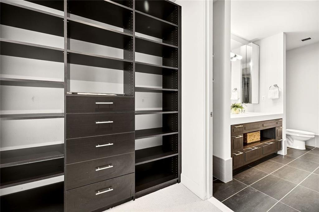 1820 Peachtree Road Northwest, Unit 905 Atlanta, GA 30309 - Photo 19 of 41 a view of walk in closet and a fireplace