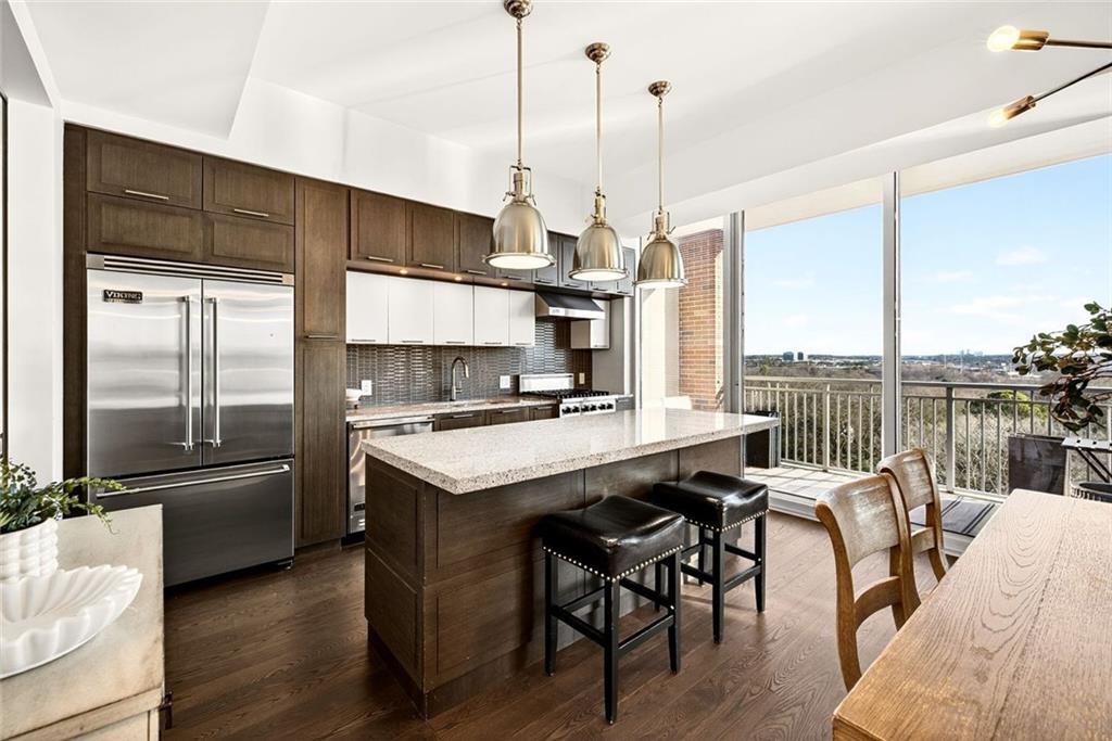 1820 Peachtree Road Northwest, Unit 905 Atlanta, GA 30309 - Photo 2 of 41 a kitchen with stainless steel appliances granite countertop a sink a stove and a refrigerator