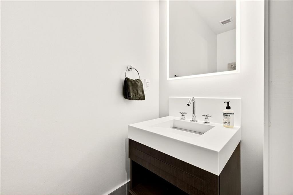 1820 Peachtree Road Northwest, Unit 905 Atlanta, GA 30309 - Photo 23 of 41 a bathroom with a sink and a mirror