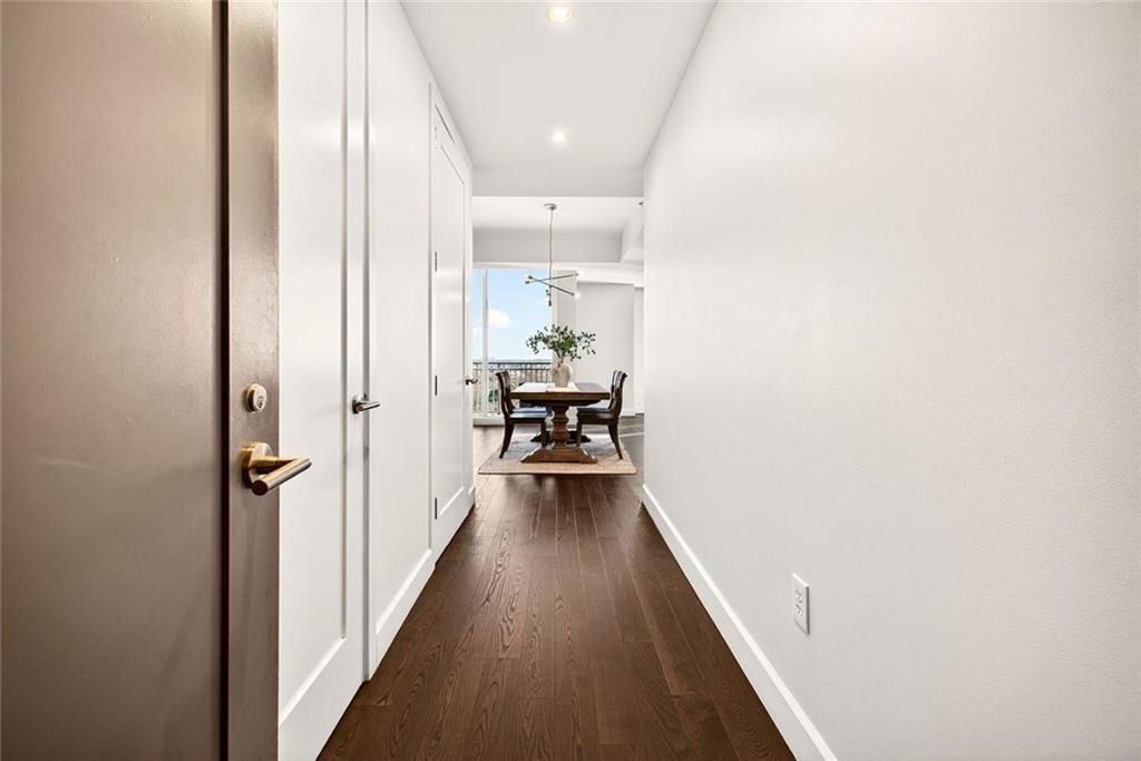 1820 Peachtree Road Northwest, Unit 905 Atlanta, GA 30309 - Photo 24 of 41 a view of a hallway with wooden floor and furniture