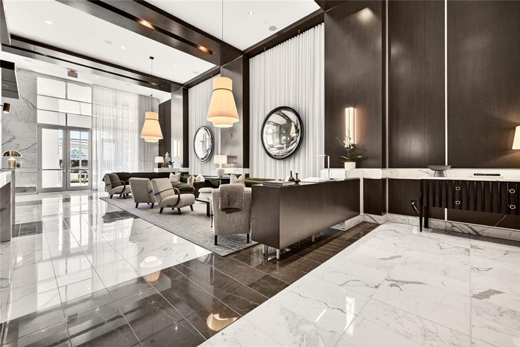 1820 Peachtree Road Northwest, Unit 905 Atlanta, GA 30309 - Photo 25 of 41 a living room with couches a large window with wooden floor