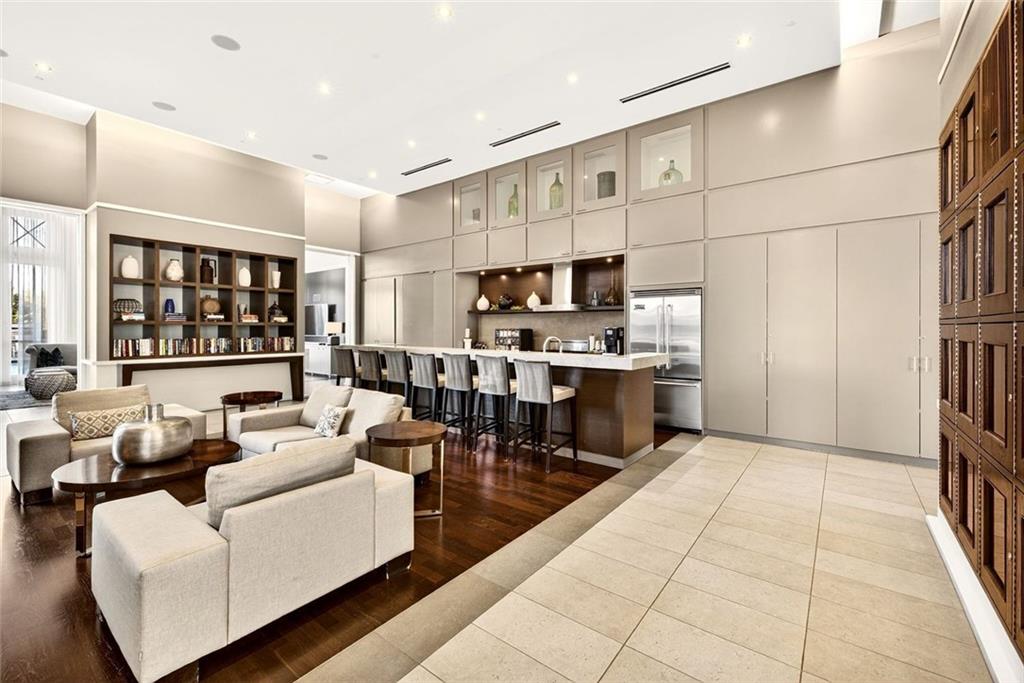 1820 Peachtree Road Northwest, Unit 905 Atlanta, GA 30309 - Photo 27 of 41 a living room with stainless steel appliances kitchen island granite countertop a refrigerator a stove a sink and a dining table with wooden floor