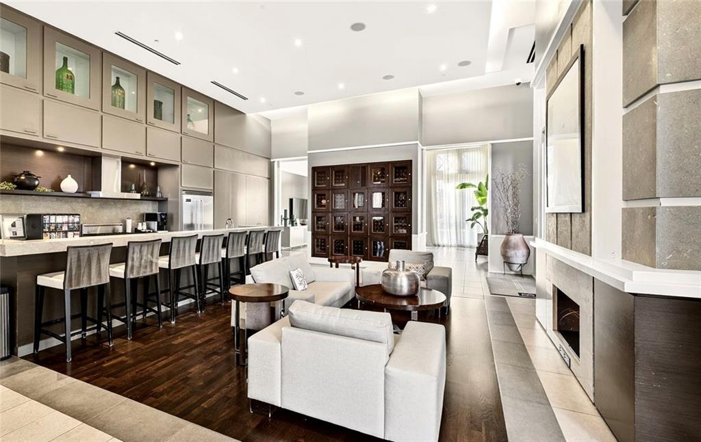 1820 Peachtree Road Northwest, Unit 905 Atlanta, GA 30309 - Photo 28 of 41 a living room with stainless steel appliances furniture a rug kitchen view and a large window