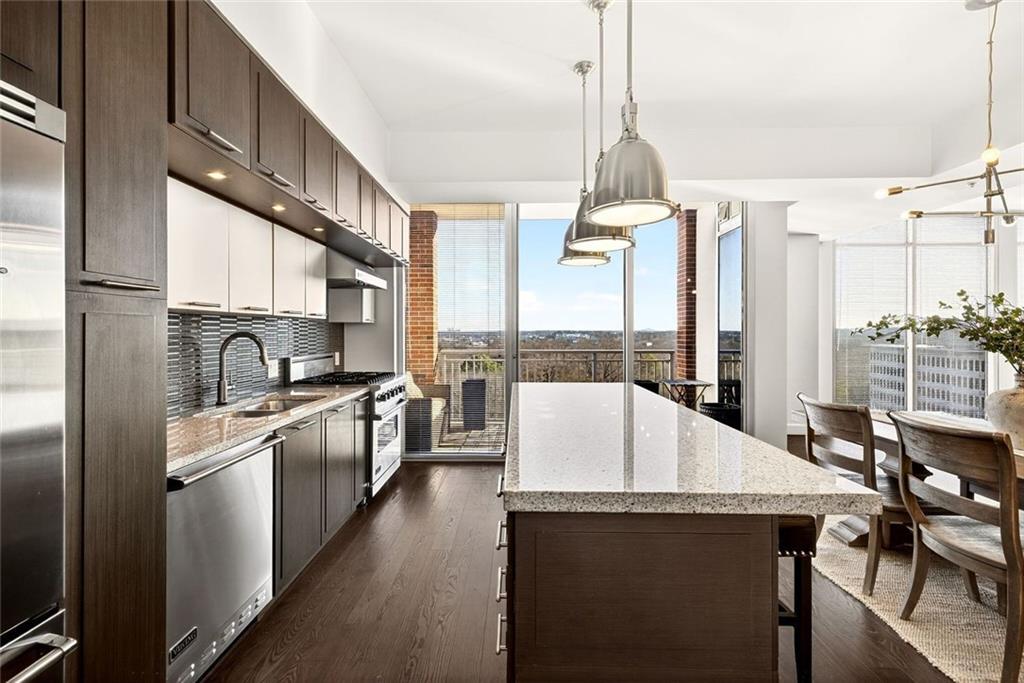 1820 Peachtree Road Northwest, Unit 905 Atlanta, GA 30309 - Photo 3 of 41 a kitchen with stainless steel appliances granite countertop a sink stove and refrigerator