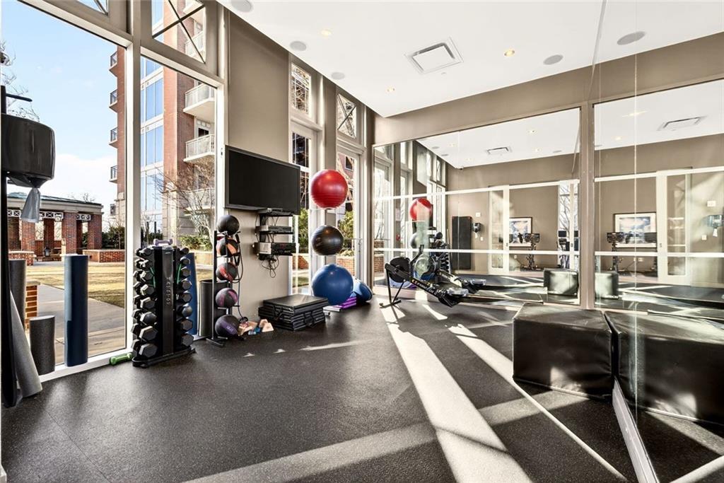 1820 Peachtree Road Northwest, Unit 905 Atlanta, GA 30309 - Photo 32 of 41 a view of a living room with furniture and a floor to ceiling window