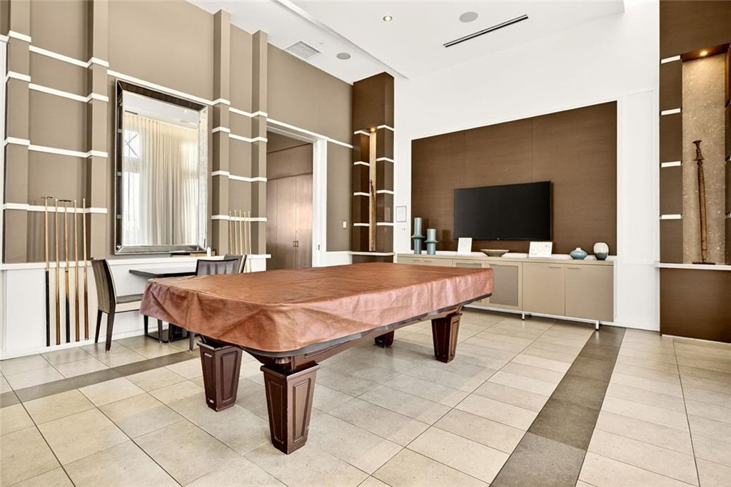 1820 Peachtree Road Northwest, Unit 905 Atlanta, GA 30309 - Photo 36 of 41 a spacious bathroom with a table chairs and a shower