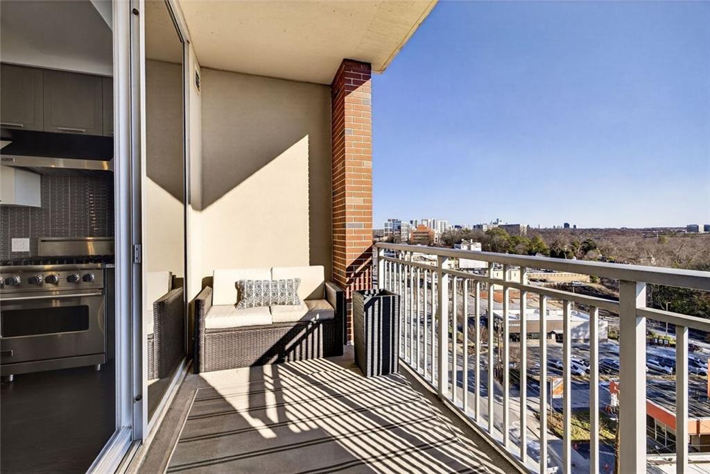 1820 Peachtree Road Northwest, Unit 905 Atlanta, GA 30309 - Photo 5 of 41 a view of balcony with couches wooden floor and fence