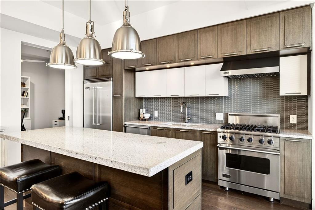 1820 Peachtree Road Northwest, Unit 905 Atlanta, GA 30309 - Photo 6 of 41 a kitchen with a stove cabinets and wooden floor