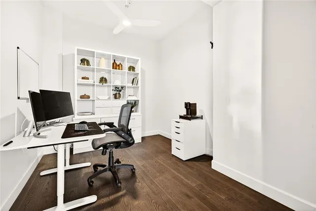 a view of a workspace with furniture and wooden floor