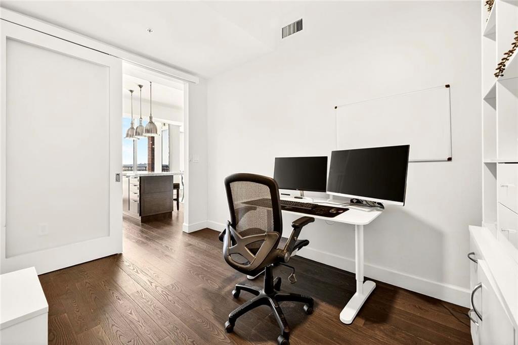 1820 Peachtree Road Northwest, Unit 905 Atlanta, GA 30309 - Photo 7 of 41 a view of a workspace with furniture and wooden floor