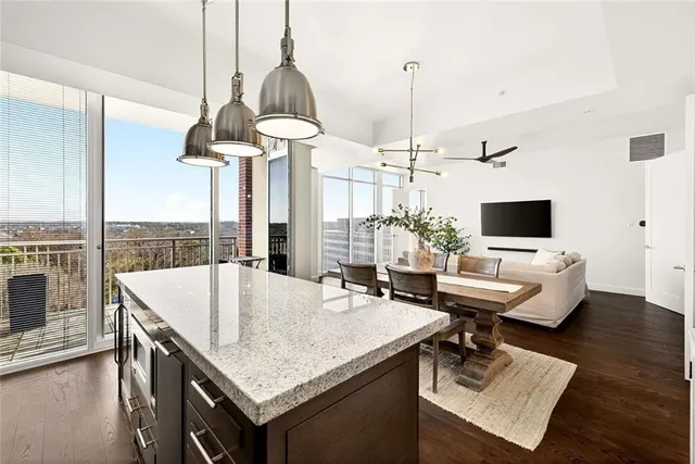 a living room with a table chairs and a wooden floor