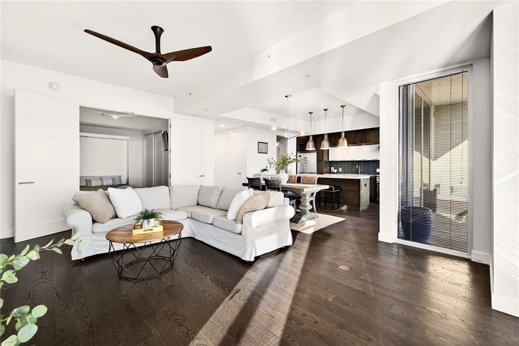 1820 Peachtree Road Northwest, Unit 905 Atlanta, GA 30309 - Photo 10 of 41 a living room with furniture and a chandelier
