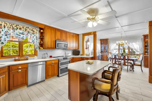 a large kitchen with a table and chairs