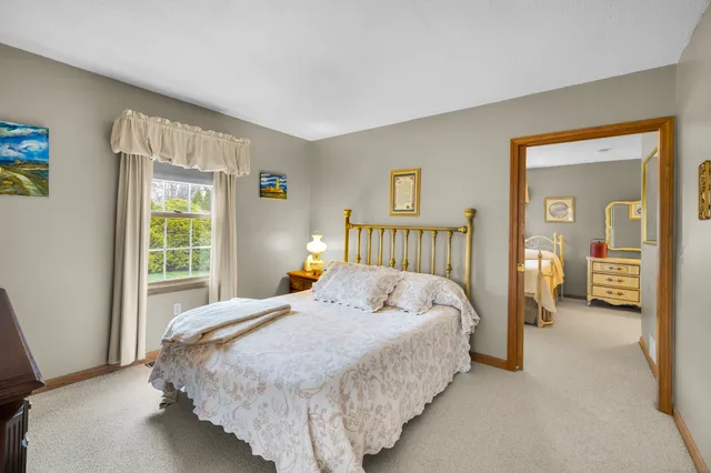 a bedroom with a large bed and a window