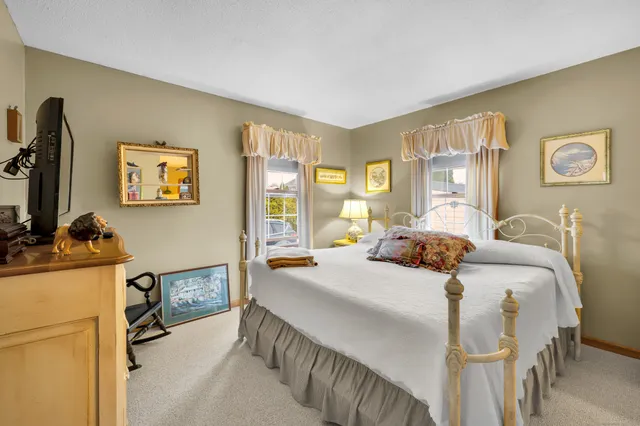 a bedroom with a bed and a desk