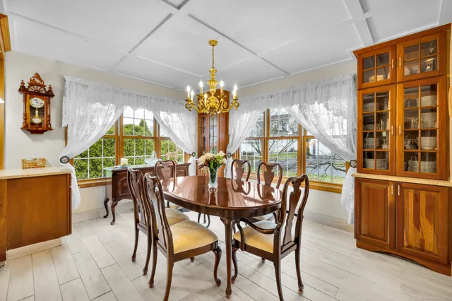 a view of a dining room with furniture and chandelier