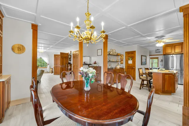 a dining room with furniture and chandelier