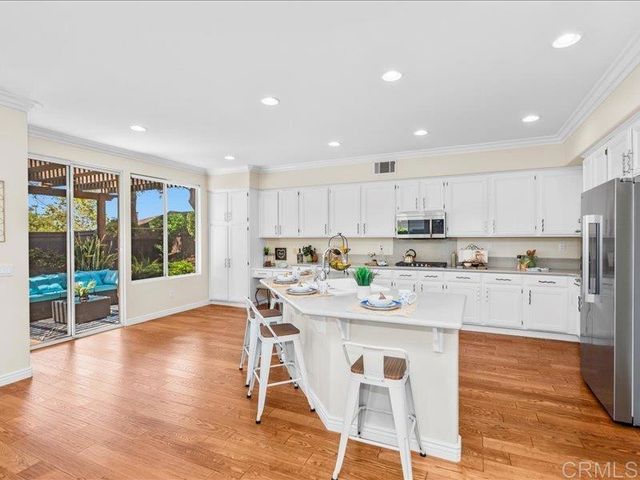 a very nice looking living room with a large window and dining table