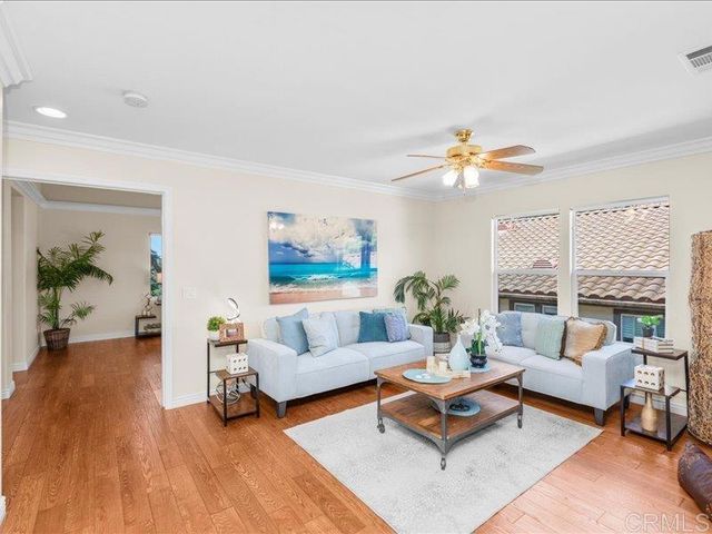 a bedroom with a large bed couch and a window