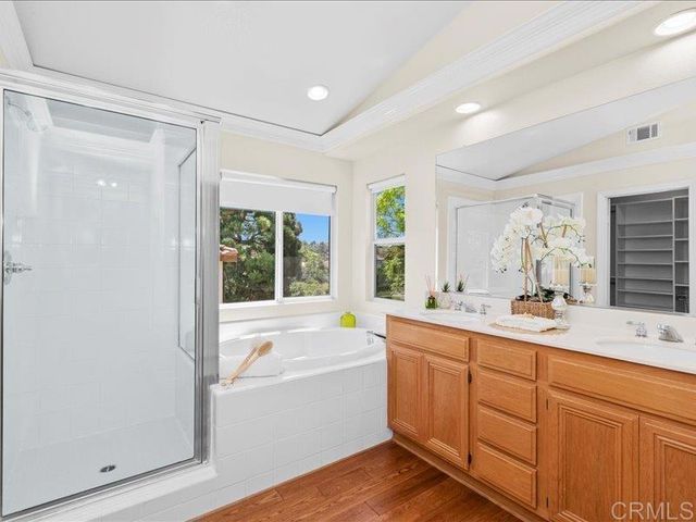 a spacious bathroom with a granite countertop sink and a mirror