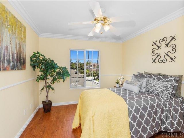 a view of a workspace with furniture and a ceiling fan