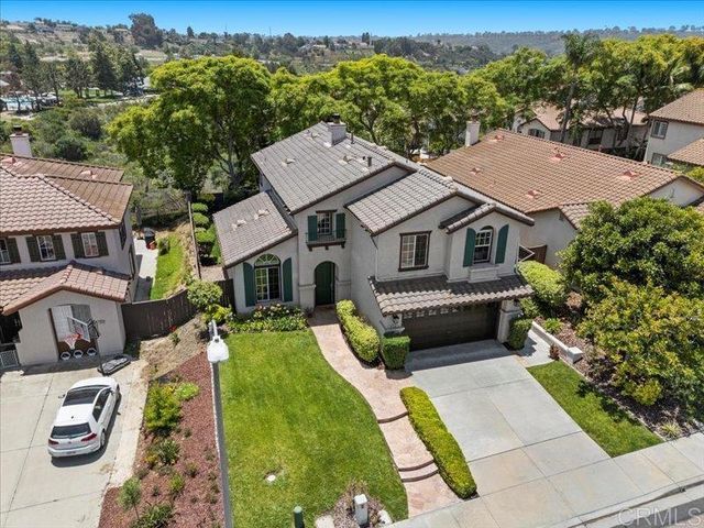 a aerial view of a house with a yard table and chairs