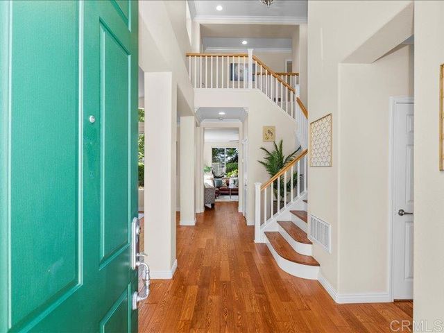 a view of entryway and hall with wooden floor