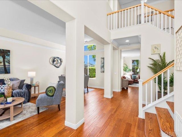 a living room with furniture a chandelier and a window