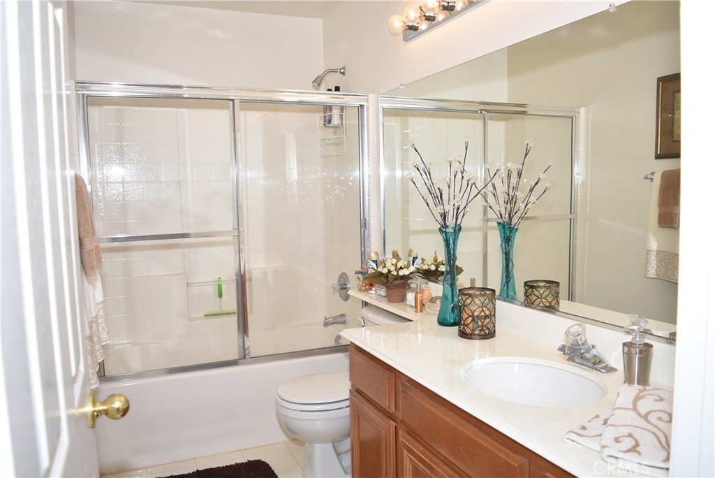 1665 Ravenswood Road Beaumont, CA 92223 - Photo 31 of 41 a bathroom with a granite countertop sink toilet and shower