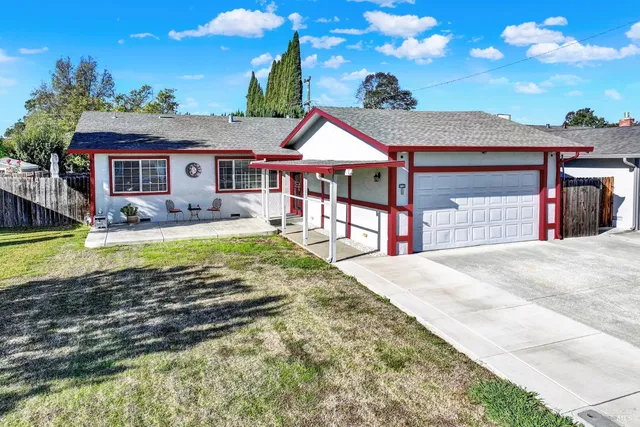 a view of a house with swimming pool and a yard