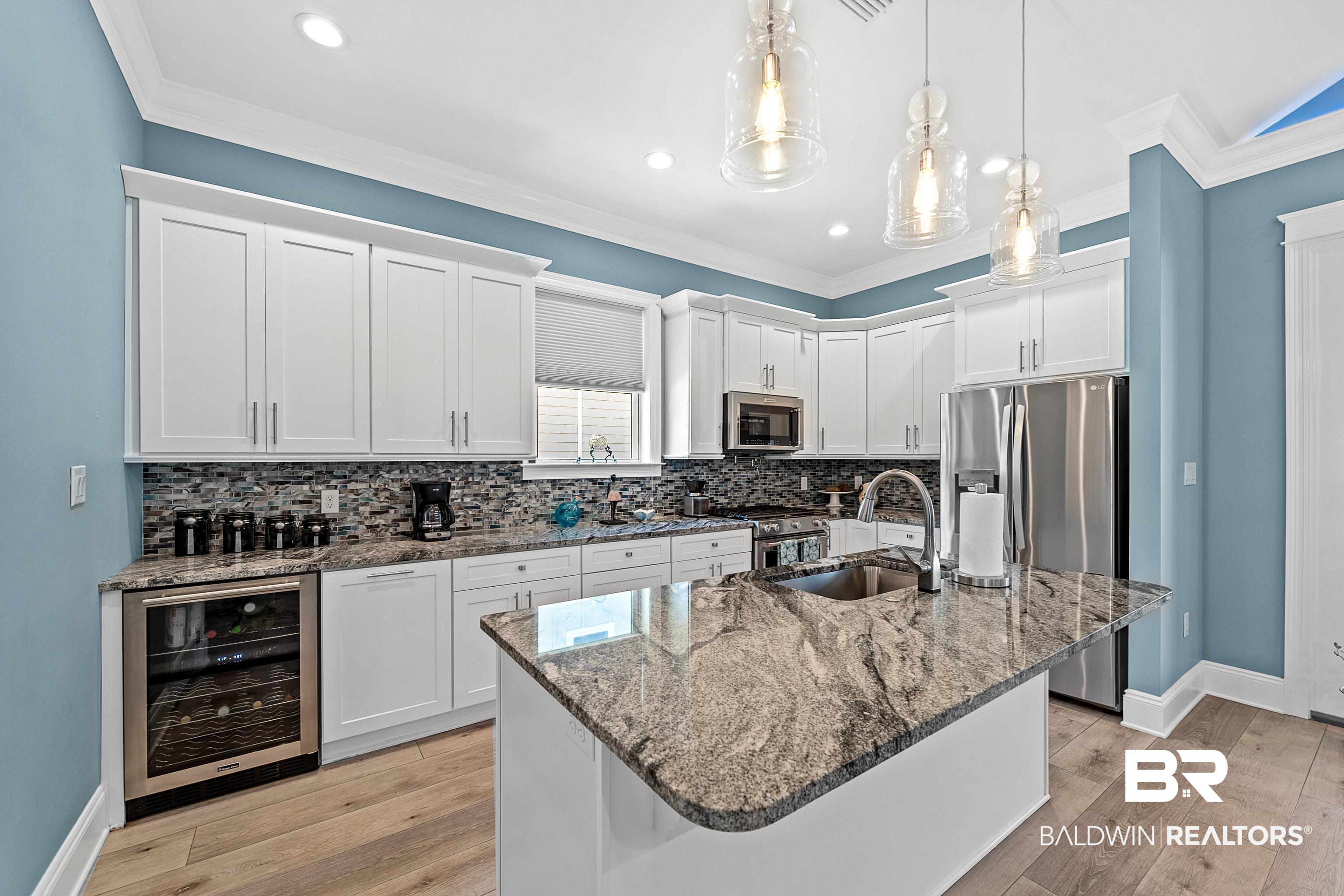 12329 Reunion Place, Unit LOT 38 Foley, AL 36535 - Photo 9 of 43 Kitchen with wine cooler, dark stone counters, white cabinetry, stainless steel appliances, and light wood finished floors